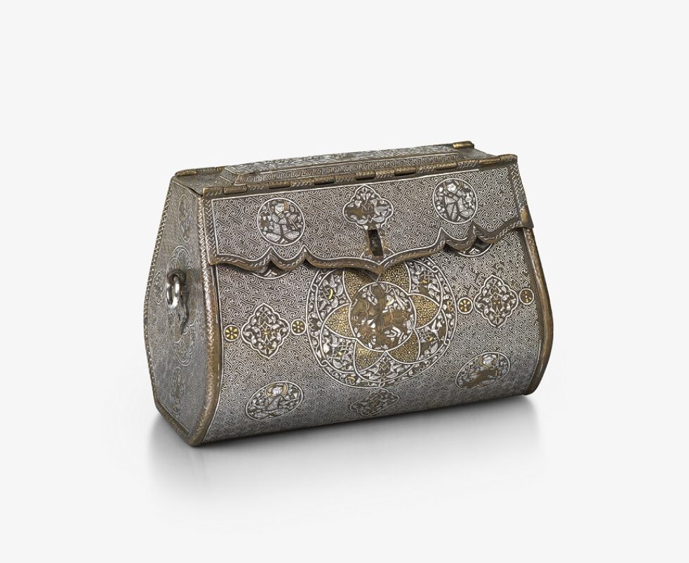 An intricate, oblong-shaped metal bag with front-closure. There are detailed illustrations at regular points across the front, and gold and silver inlays.