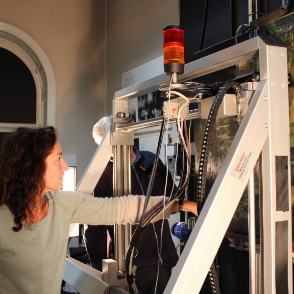 An image of Courtauld staff using The Bruker X-ray Fluorescence Scanning Instrument applied in the analysis of Édouard Manet’s “Déjeuner sur l'herbe” from the Courtauld Gallery