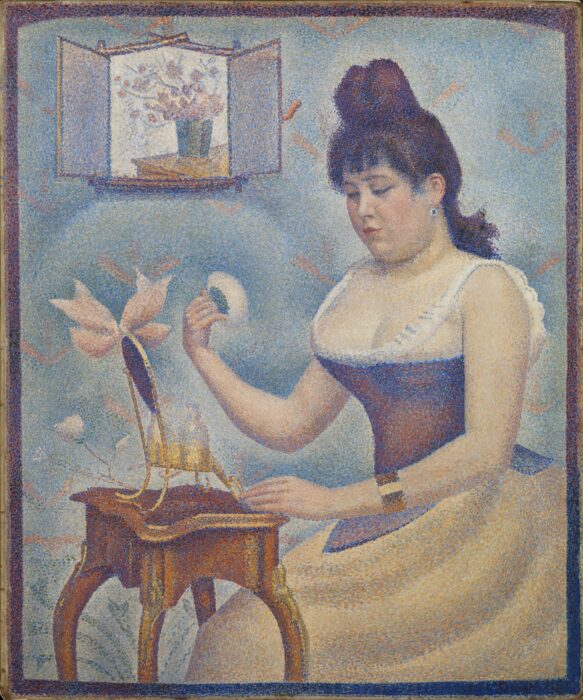 A painting, using the classic pointillist technique of lots of tiny dots of colour made up to reveal a bigger picture, of a woman, wearing a corset and skirt, powdering her face while seated in front of a small table and mirror. In the top corner there is a frame, with a vase of flowers painted in.