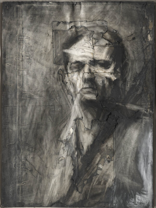 Charcoal drawing of a man, Frank Auerbach, sitting slightly side-on to the viewer and staring at us with a stern expression. The background is roughly completed, and the face somewhat fragmented by the background.