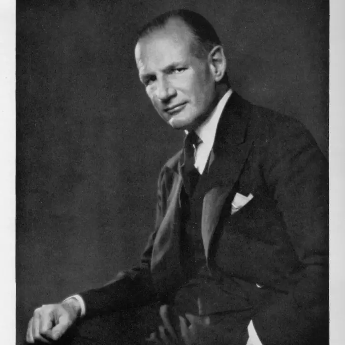 Black and white photograph of Samuel Courtauld, wearing a suit and sitting down, looking straight at the camera