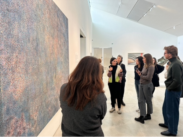 a student group in a gallery looking at a painting