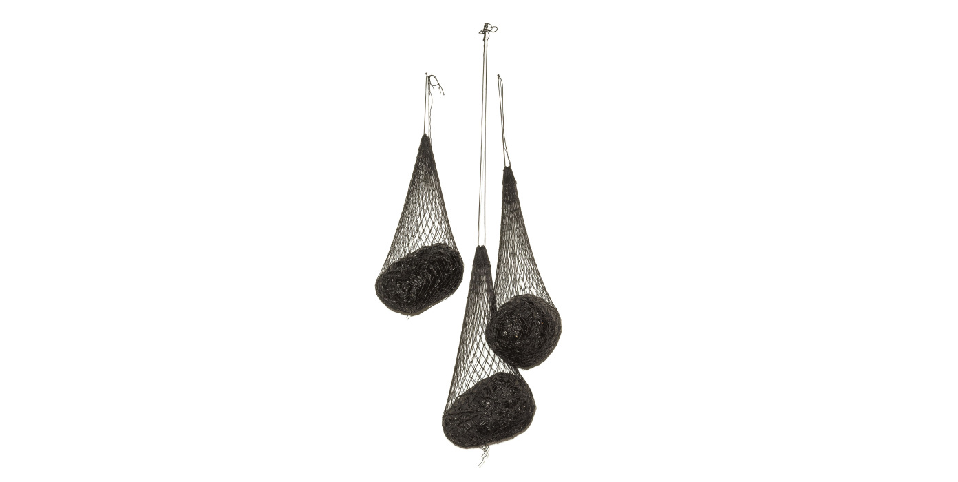 Sculpture with three dark nets hanging