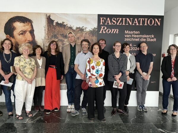 Group standing at the entrance of an art exhibition